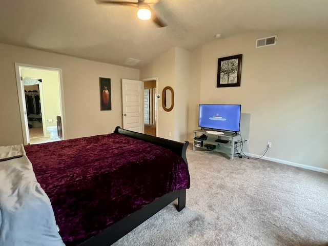 bedroom featuring carpet, ceiling fan, ensuite bath, and vaulted ceiling