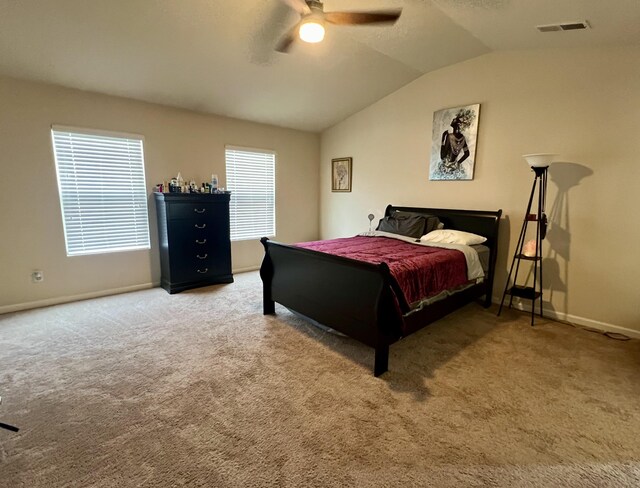 carpeted bedroom with ceiling fan and lofted ceiling