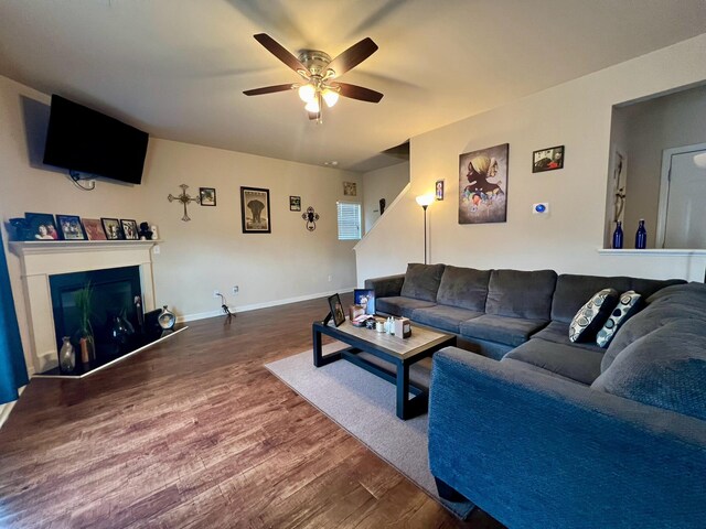 living room with hardwood / wood-style flooring and ceiling fan