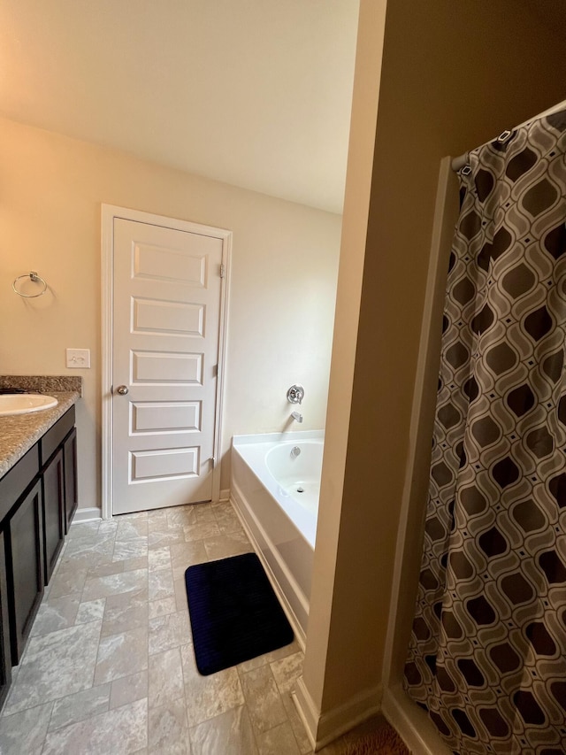 bathroom with vanity and shower with separate bathtub