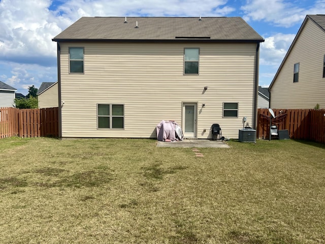 back of property with a lawn, cooling unit, and a patio