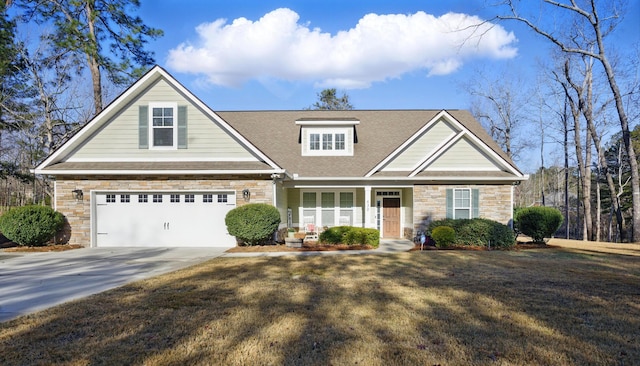 view of front of house featuring concrete driveway, a garage, stone siding, and a front yard