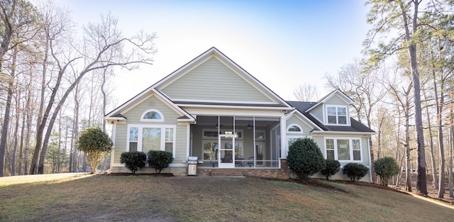 view of front of house with a front yard and a sunroom