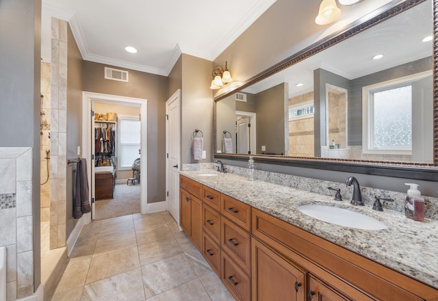 full bathroom featuring crown molding, a walk in shower, visible vents, and a sink