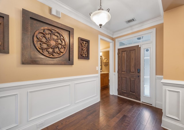 entrance foyer with visible vents, dark wood-type flooring, a wainscoted wall, and crown molding