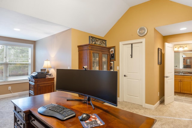 office with light carpet, baseboards, lofted ceiling, and a sink