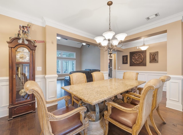 dining area featuring dark wood-style floors, visible vents, wainscoting, and an inviting chandelier