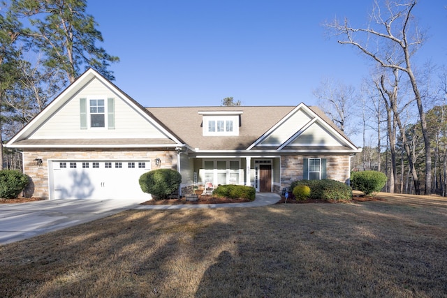 view of front of home featuring stone siding, an attached garage, concrete driveway, and a front lawn