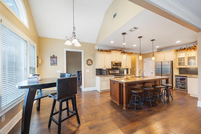 kitchen featuring a sink, visible vents, wine cooler, and appliances with stainless steel finishes