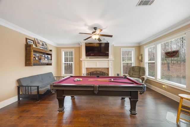 game room featuring visible vents, a healthy amount of sunlight, ornamental molding, and wood finished floors