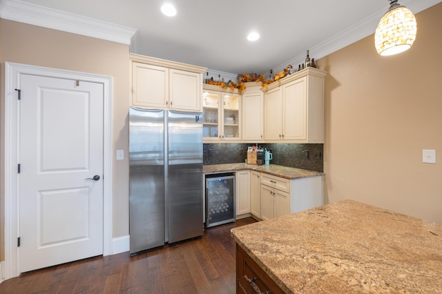 kitchen with light stone countertops, beverage cooler, ornamental molding, decorative backsplash, and freestanding refrigerator