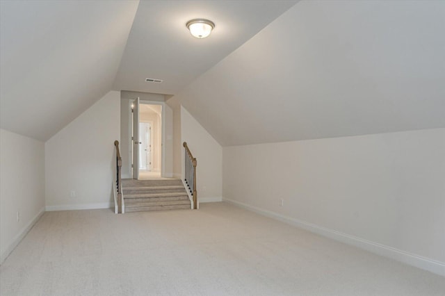 bonus room with carpet and lofted ceiling