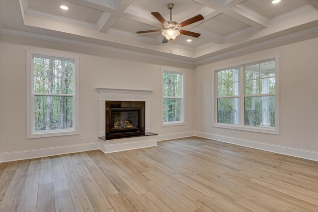 unfurnished living room with light wood-type flooring, coffered ceiling, ceiling fan, crown molding, and beam ceiling