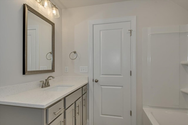 bathroom with vanity and a tub