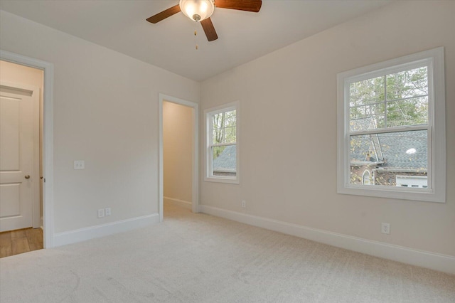 unfurnished room featuring ceiling fan and light carpet