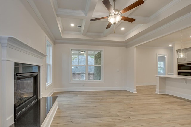 unfurnished living room with beam ceiling, light hardwood / wood-style flooring, coffered ceiling, and a healthy amount of sunlight