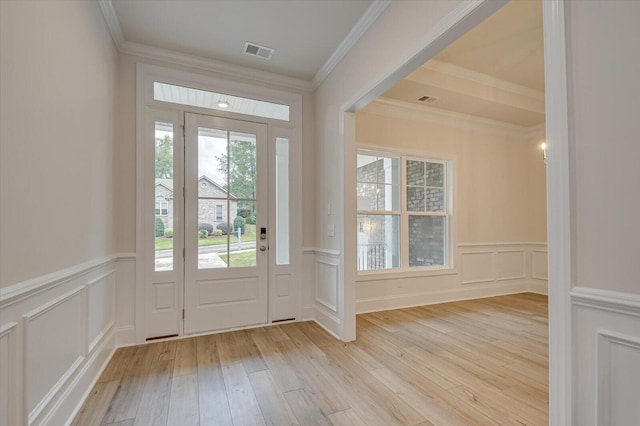 foyer featuring light hardwood / wood-style flooring and ornamental molding