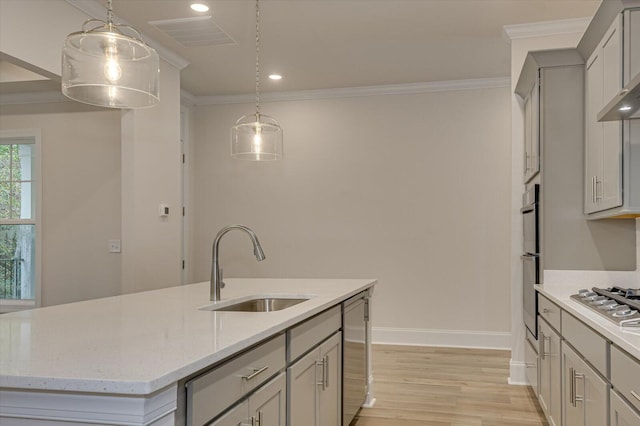 kitchen featuring light stone countertops, sink, pendant lighting, a center island with sink, and gray cabinets