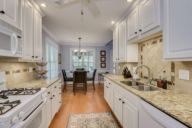 79 Loggerhead Dr, Columbia, SC 29229 - kitchen with white appliances, white cabinetry, light wood-style flooring, crown molding, and a chandelier