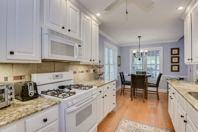 79 Loggerhead Dr, Columbia, SC 29229 - kitchen with white appliances, white cabinets, light wood-type flooring, a chandelier, and crown molding