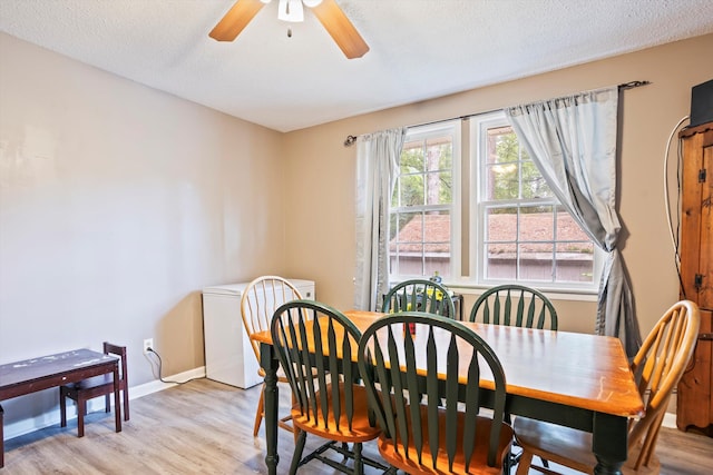 520 Central Rd, Thomson, GA 30824 - dining space with light wood-type flooring, a ceiling fan, baseboards, and a textured ceiling