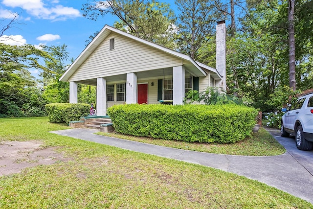 520 Central Rd, Thomson, GA 30824 - view of front facade featuring covered porch, a front lawn, and a chimney