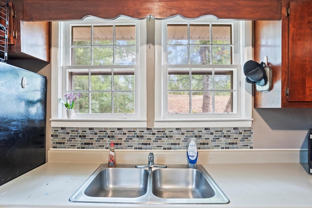 520 Central Rd, Thomson, GA 30824 - kitchen featuring a sink, light countertops, and decorative backsplash
