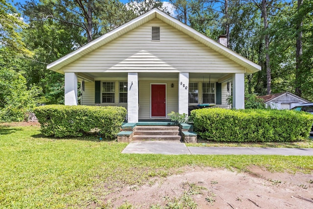 520 Central Rd, Thomson, GA 30824 - bungalow-style house featuring a chimney, covered porch, and a front lawn