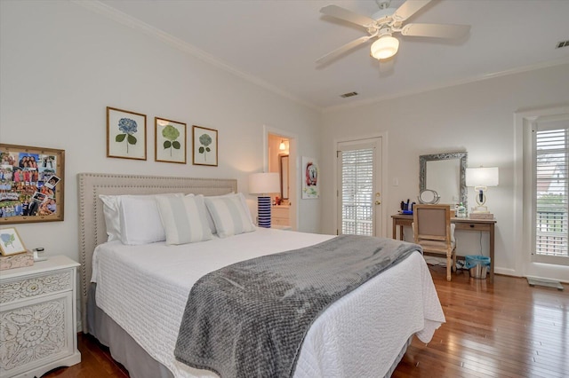 bedroom featuring dark wood-type flooring, visible vents, and ornamental molding