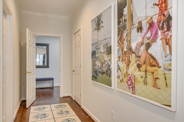 hall with dark wood-style floors, baseboards, and ornamental molding