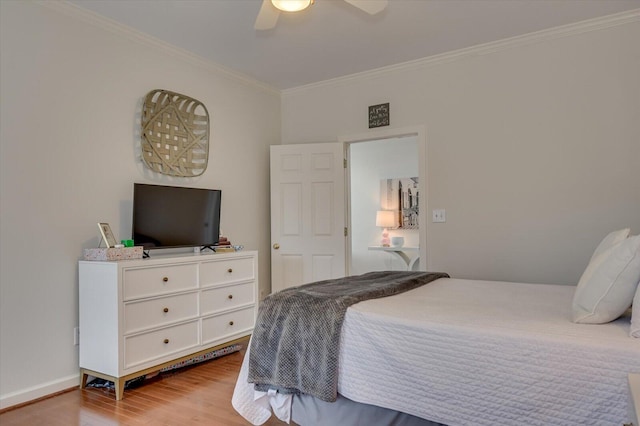 bedroom featuring baseboards, a ceiling fan, wood finished floors, and crown molding