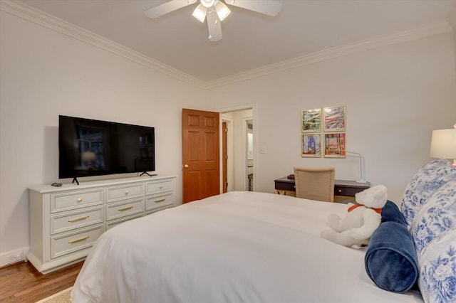 bedroom featuring wood finished floors, ornamental molding, and a ceiling fan