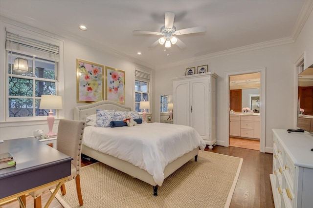 bedroom featuring ornamental molding, recessed lighting, wood finished floors, ensuite bath, and a ceiling fan