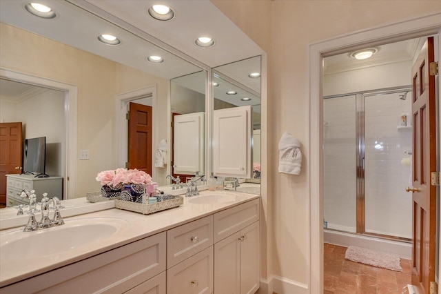 bathroom featuring a shower stall, crown molding, and a sink