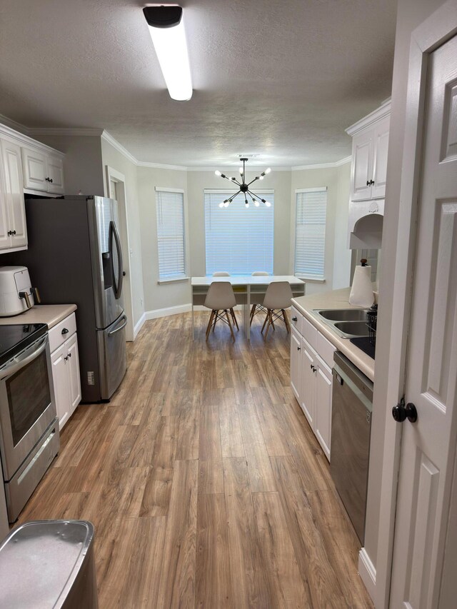 1229 Creek Bend Dr, Grovetown, GA 30813 - kitchen featuring stainless steel appliances, white cabinetry, wood finished floors, a chandelier, and a textured ceiling