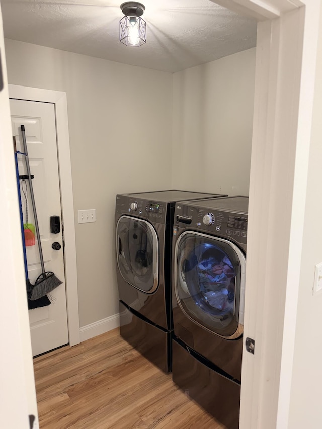1229 Creek Bend Dr, Grovetown, GA 30813 - laundry area with washer and dryer, light wood finished floors, baseboards, and a textured ceiling