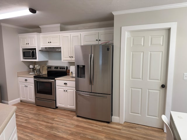 1229 Creek Bend Dr, Grovetown, GA 30813 - kitchen with appliances with stainless steel finishes, under cabinet range hood, crown molding, light countertops, and white cabinets