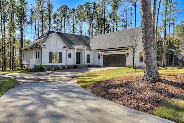 view of front of home with a garage and a front yard