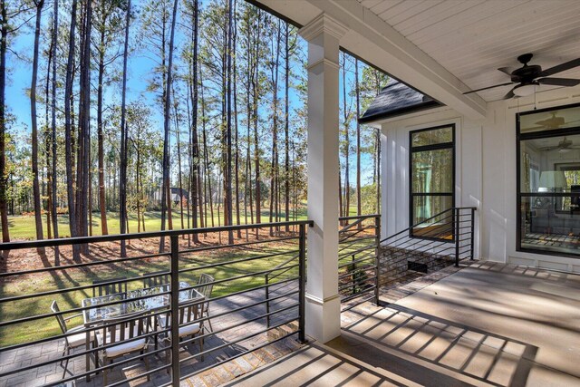 wooden terrace featuring ceiling fan and covered porch