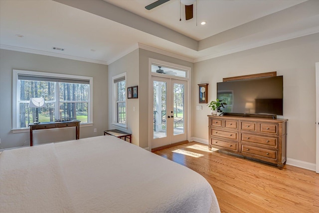 bedroom featuring french doors, light wood-type flooring, ornamental molding, access to outside, and ceiling fan