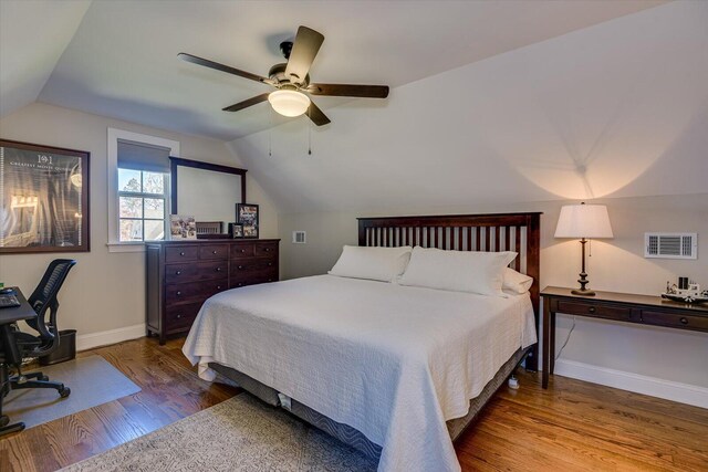 bedroom featuring wood-type flooring, vaulted ceiling, and ceiling fan