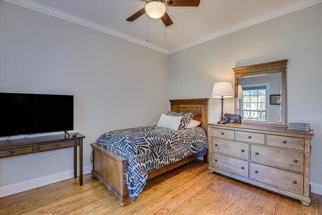 bedroom with light wood-type flooring, ceiling fan, and crown molding