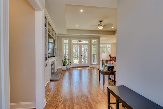 entryway featuring ceiling fan, french doors, and light wood-type flooring