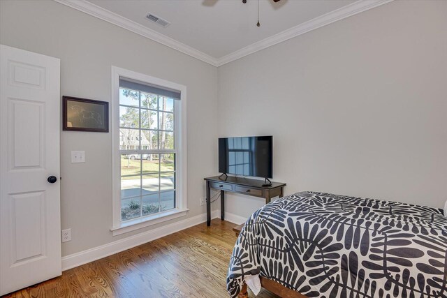 bedroom featuring crown molding and wood-type flooring