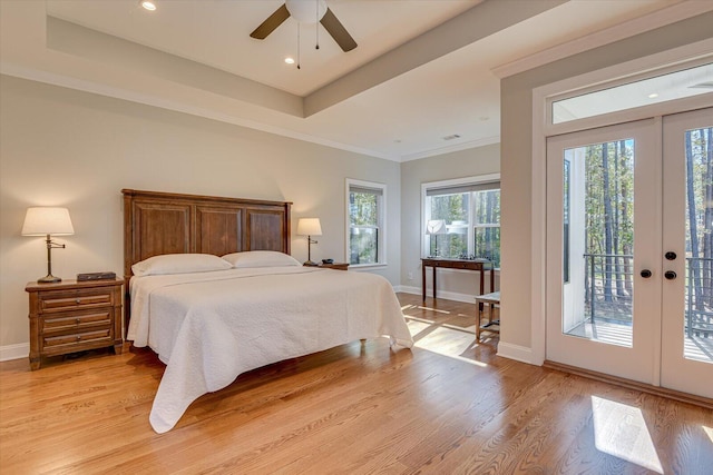 bedroom featuring access to exterior, ceiling fan, french doors, a raised ceiling, and light hardwood / wood-style floors