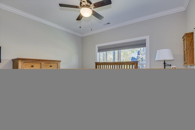 bedroom featuring ceiling fan and ornamental molding