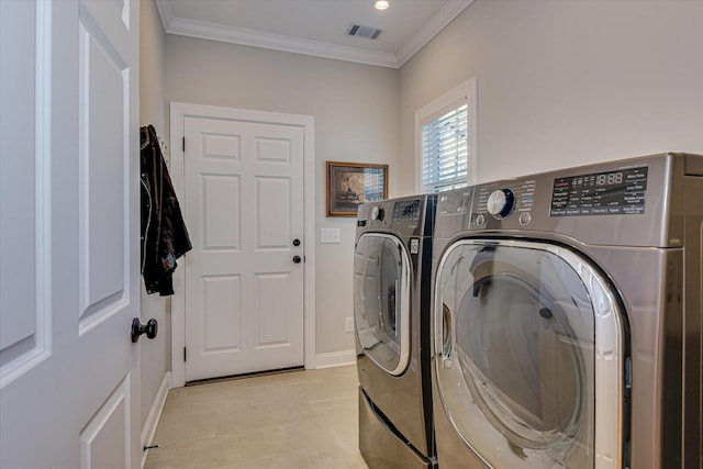 clothes washing area with separate washer and dryer and crown molding