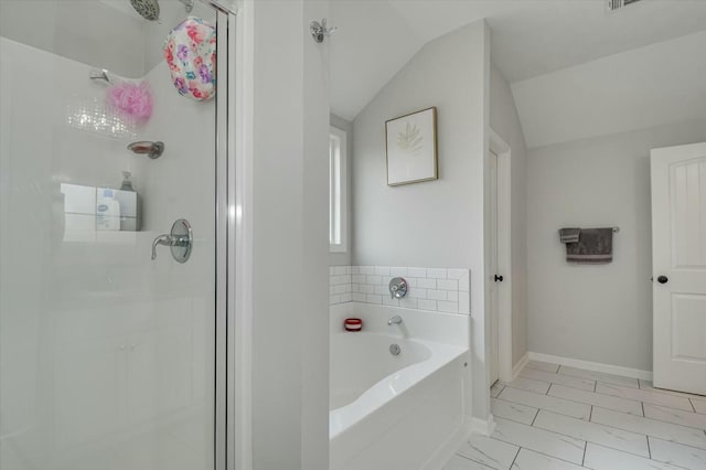 bathroom featuring independent shower and bath and vaulted ceiling