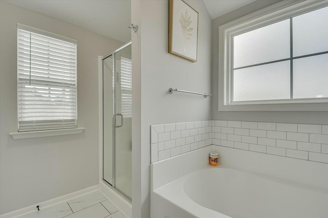 bathroom featuring separate shower and tub