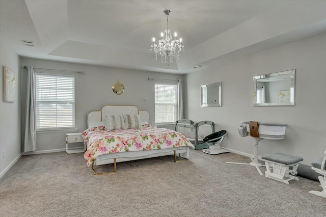 bedroom featuring a raised ceiling, carpet, and a notable chandelier